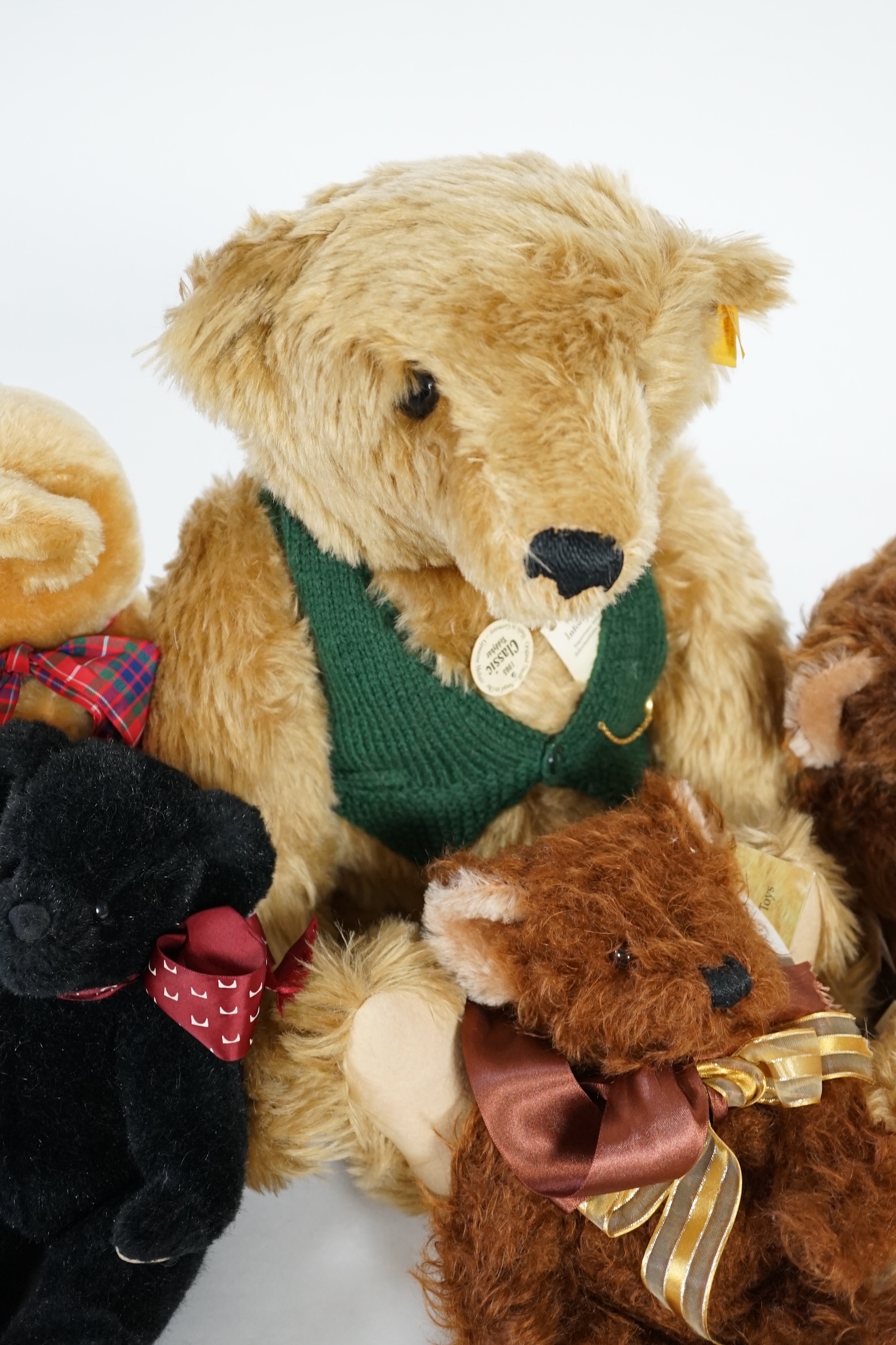 A large 1906 Steiff orange label, two Merrythought John Lewis bears, a black Merrythought bear, an artist bear and a Merrythought Alfred bear (6)